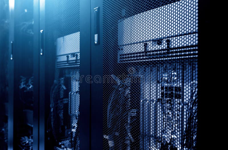 Modern server rack cluster under meshed door in big data centre with blue neon toning. Close up. Internet provider royalty free stock image