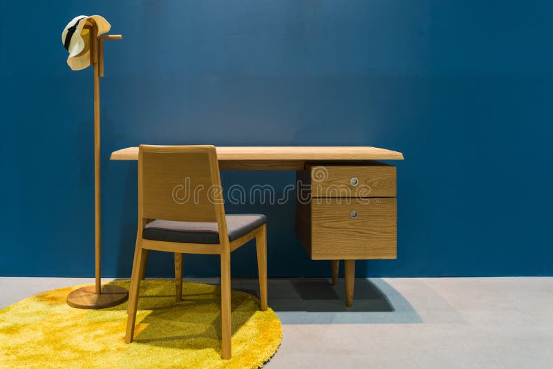 Modern set of wooden table chair with hat hanger and blue wall interior for home and living achitecture decoration contemporary