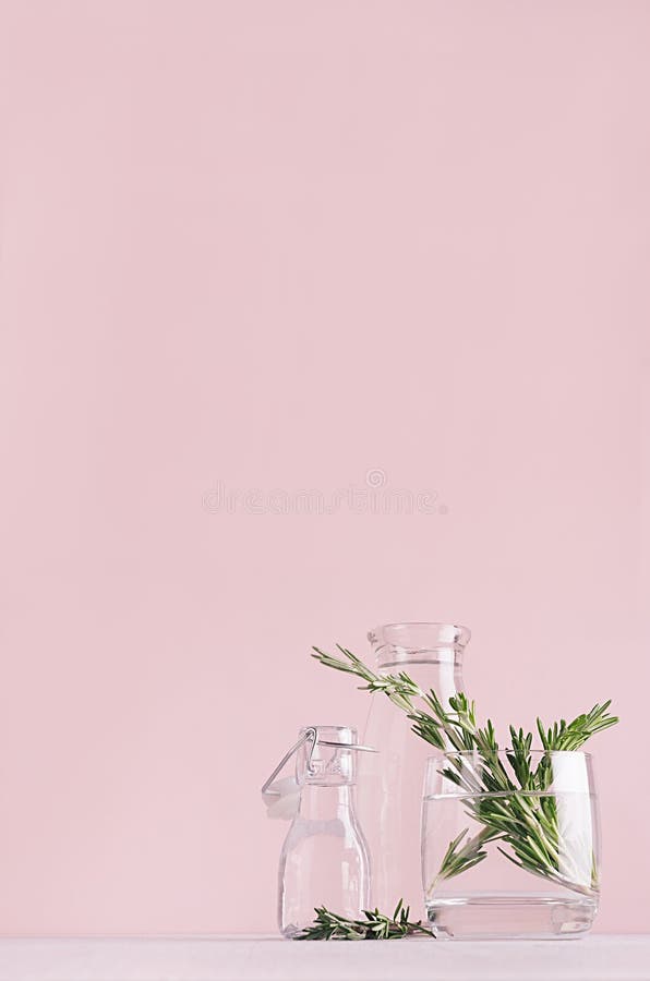 Modern simple art pink home decor with green plant in transparent vases on soft light white wood table, vertical. royalty free stock photo Modern simple art pink home decor with green plant in transparent vases on soft light white wood table, vertical. royalty free stock photo