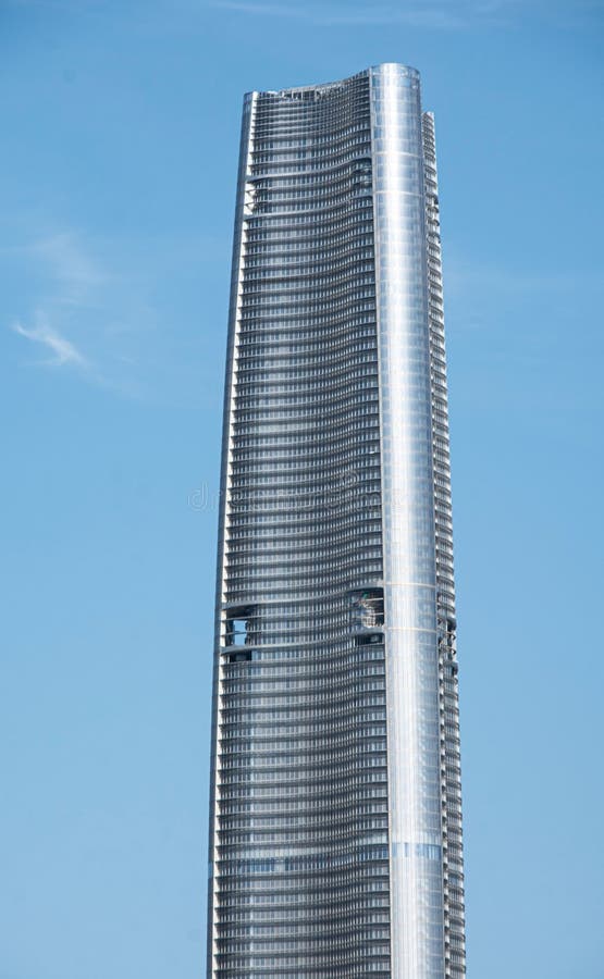 Modern curved skyscraper against clear blue sky. royalty free stock photography