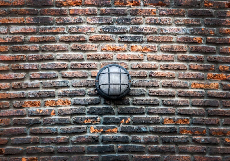 Modern street electric lamp on the old brick wall