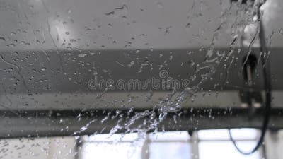 Water Drops on the Windshield in a Car Washer Blowing Stock