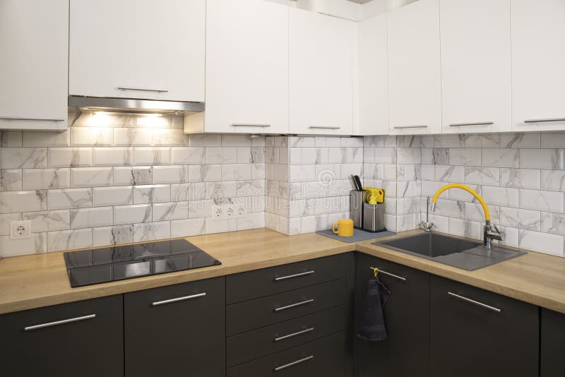 Modern and Stylish White and Grey Kitchen with Yellow Accents Stock