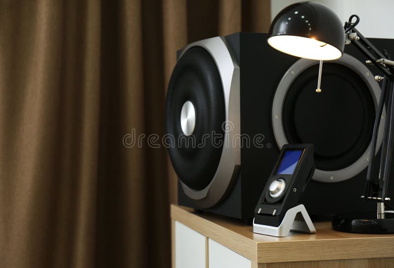 Modern Subwoofer, Remote and Lamp on Indoors, Space for Text