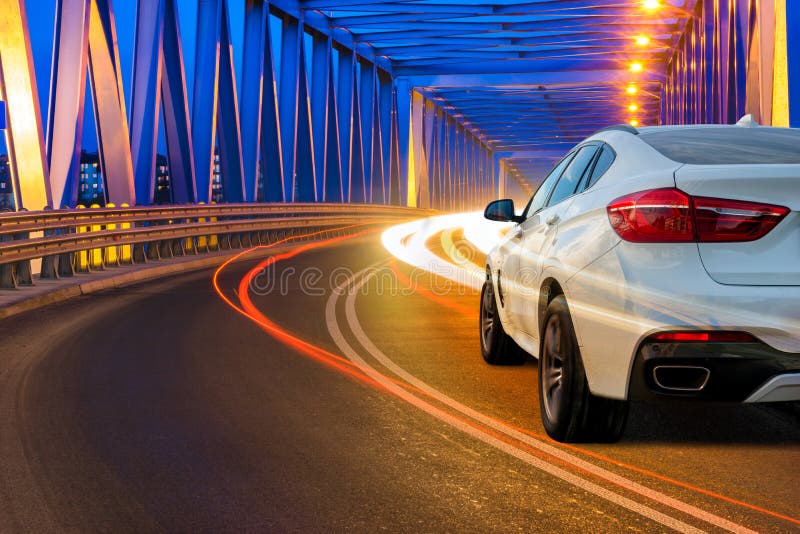 Modern SUV driving across the bridge at night stock images Modern SUV driving across the bridge at night stock images
