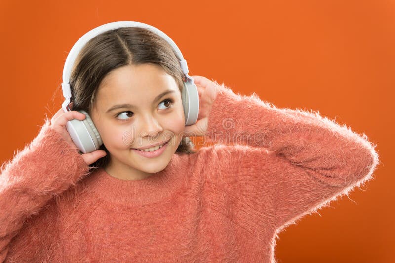 Modern technology is amazing. Small child wearing headphones with bluetooth technology. Little girl listening to music stock images Modern technology is amazing. Small child wearing headphones with bluetooth technology. Little girl listening to music stock images