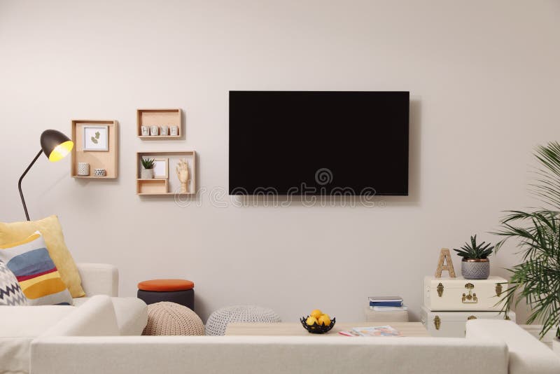 Modern TV, Comfortable Sofa and Decor Elements in Living Room Stock