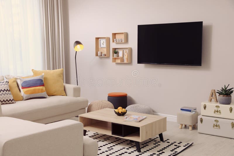 Modern TV, Comfortable Sofa and Decor Elements in Living Room Stock