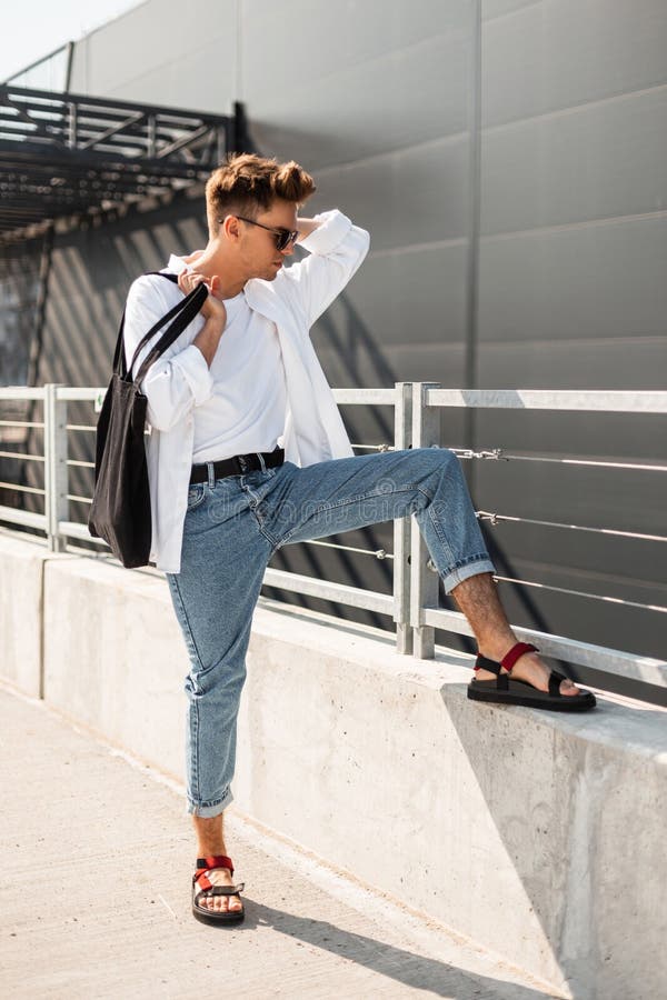 Modern Urban Young Man with Hairstyle in an Elegant Shirt in Blue Jeans ...