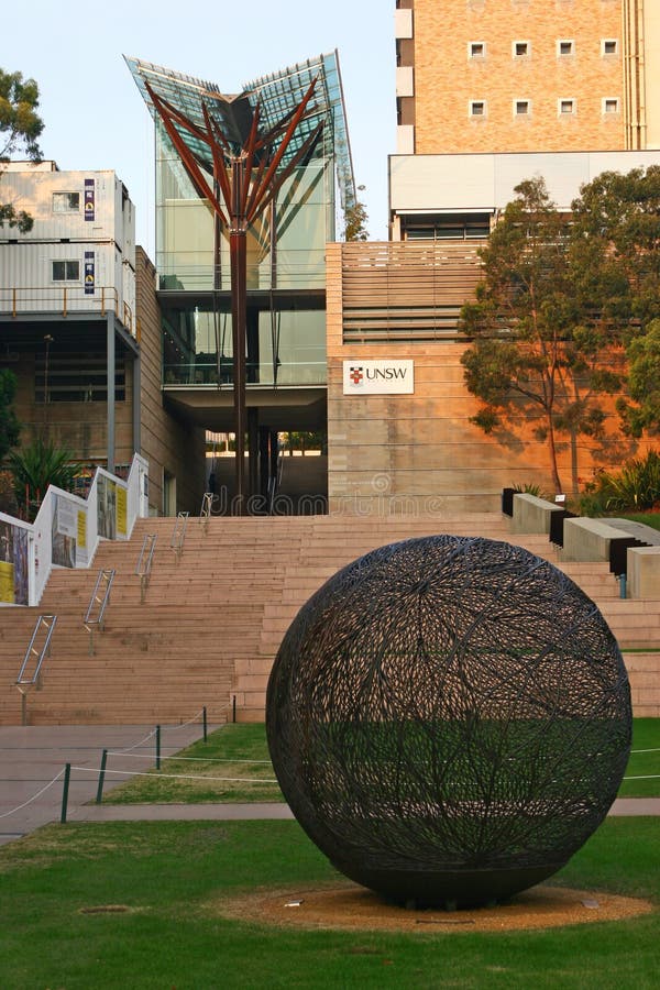 Modern V-shaped glass canopy with brown timber column and tree branches on stairs at John Niland Scientia Building on UNSW campus