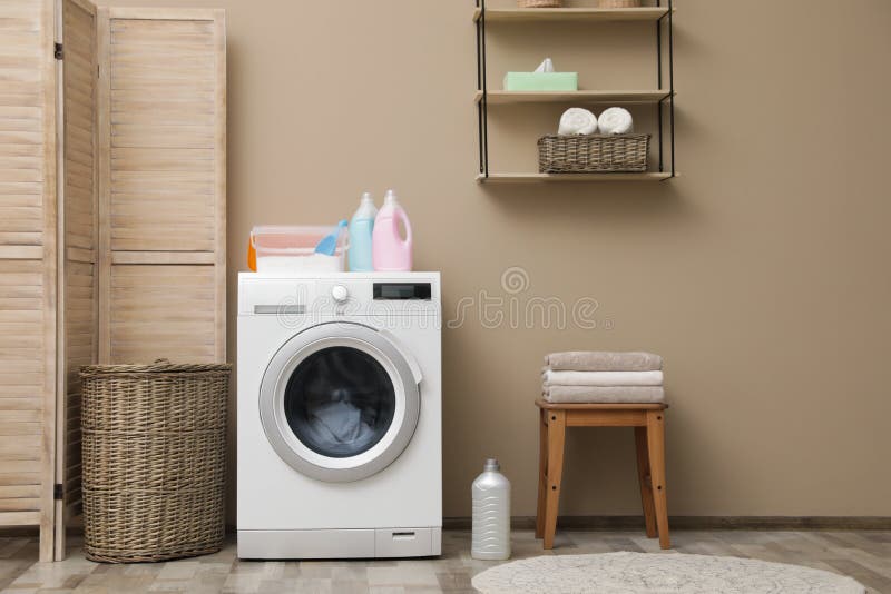 Modern washing machine near color wall in laundry room interior royalty free stock photography Modern washing machine near color wall in laundry room interior royalty free stock photography