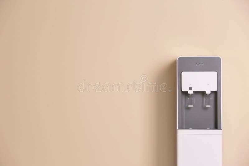 Modern water cooler against color background stock photos