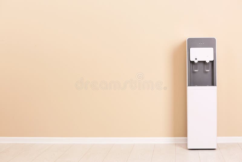 Modern water cooler against color wall stock photography