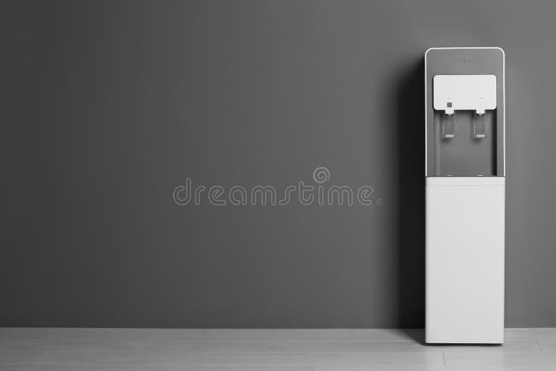 Modern water cooler against gray wall royalty free stock photography