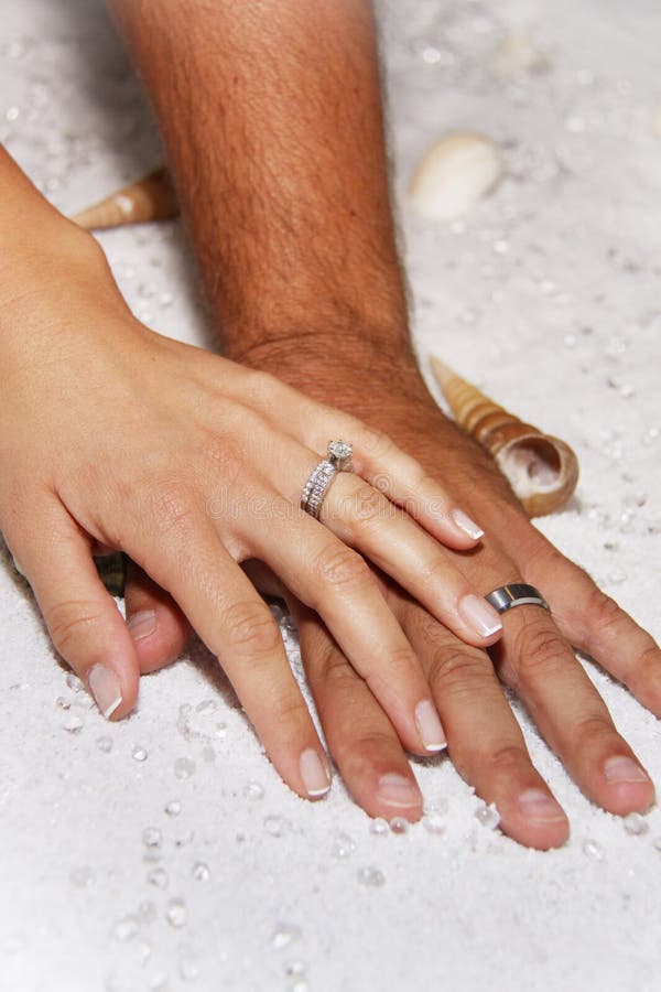 Modern Wedding hands in white sands