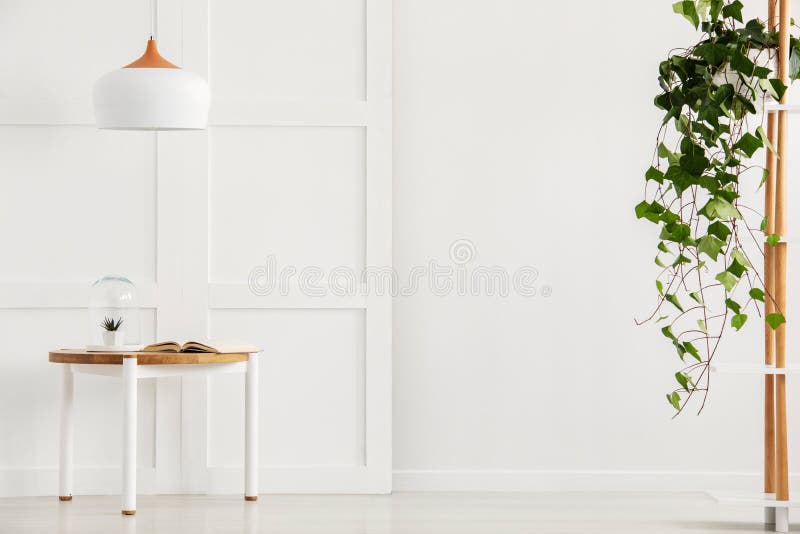 Modern white corridor with simple table and lamp