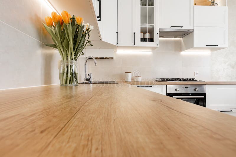 A Modern White Kitchen Interior with Wooden Worktop Stock Photo Image