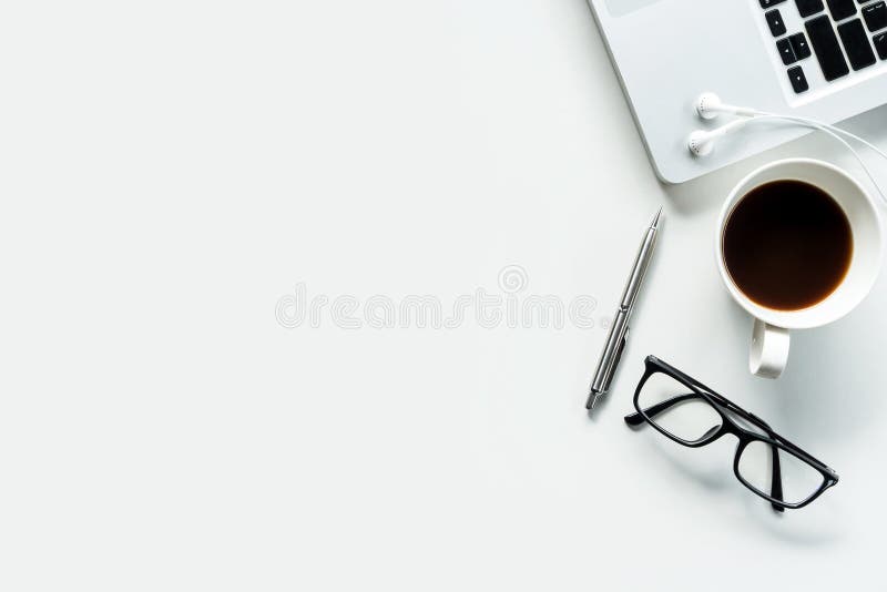 Modern white office desk table with laptop, cup of coffee and supplies. stock photo