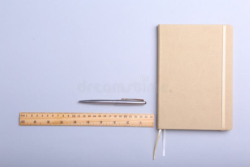 Modern white office desk table with laptop, smartphone and other supplies. Blank notebook page for input the text in the stock photography Modern white office desk table with laptop, smartphone and other supplies. Blank notebook page for input the text in the stock photography