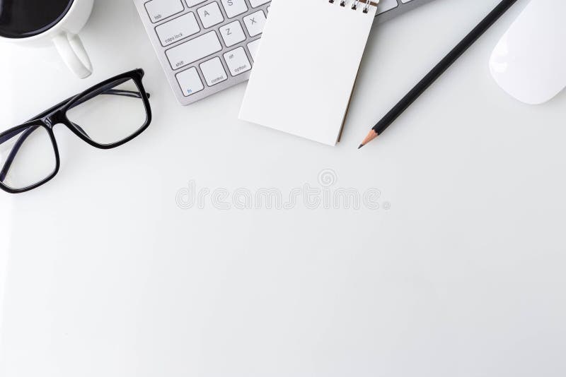 Modern white office desk top table with computer laptop, notebook and other supplies. Top view with copy space on white royalty free stock image