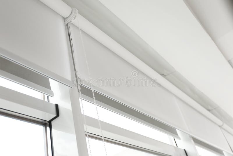 Modern window with white roller blinds royalty free stock photo