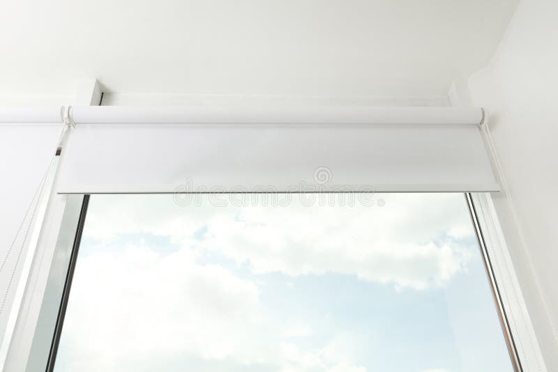 Modern window with white roller blinds indoors royalty free stock photography