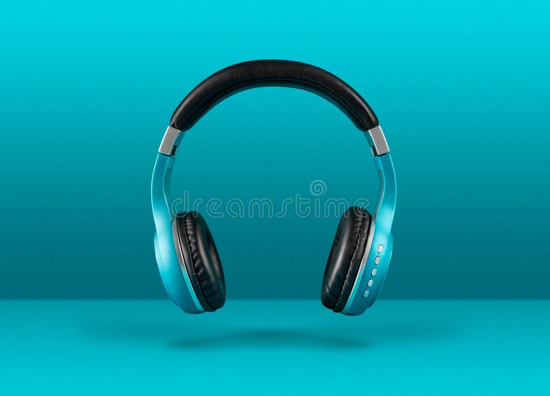Modern Wireless Headphones Floating Over Blue Background Stock Photo