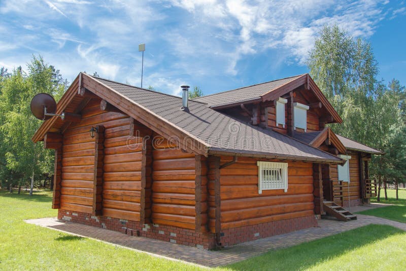 A modern wooden house made of logs. View from outside in summer. Rustic wooden log house stock images, royalty-free photos and pictures