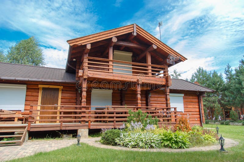 A modern wooden house made of logs. View from outside in summer. Rustic wooden log house stock images, royalty-free photos and pictures