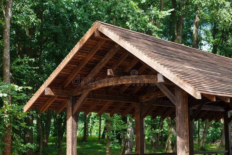 Modern wooden roof, canopy, on a background of green trees. stock photos Modern wooden roof, canopy, on a background of green trees. stock photos