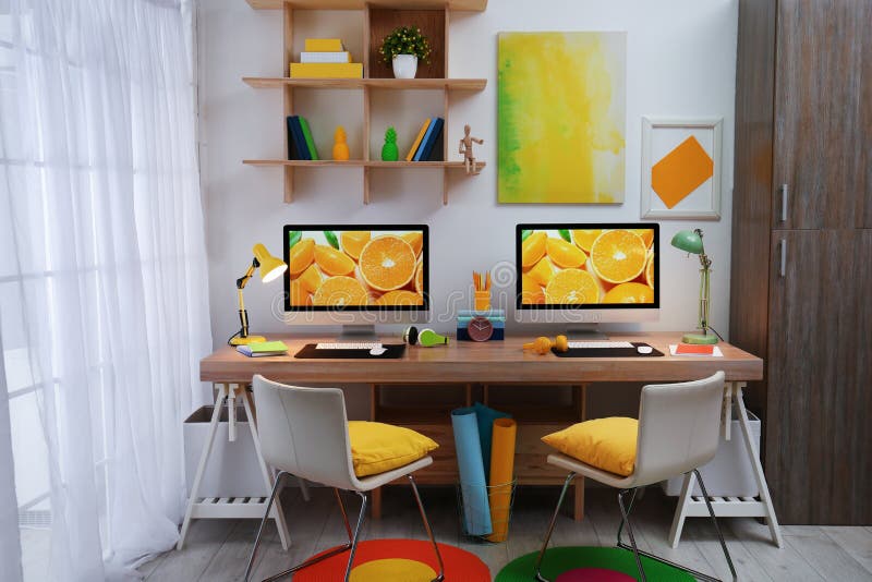Modern Workplace with Large Desk and Computers in Room Stock Photo
