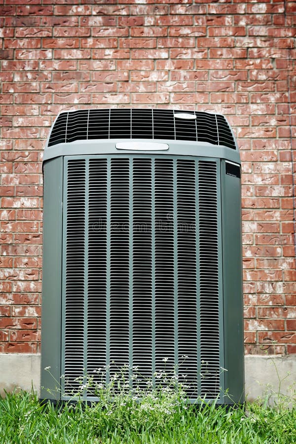 High efficiency modern AC-heater unit on brick wall background. High efficiency modern AC-heater unit on brick wall background