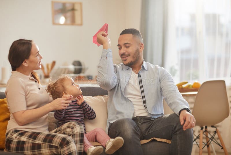 Moderne familie speelt met klein meisje thuis stock afbeelding Moderne familie speelt met klein meisje thuis stock afbeelding