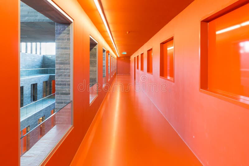 Interior modern building with open windows and several floors and orange painted passages. Interior modern building with open windows and several floors and orange painted passages