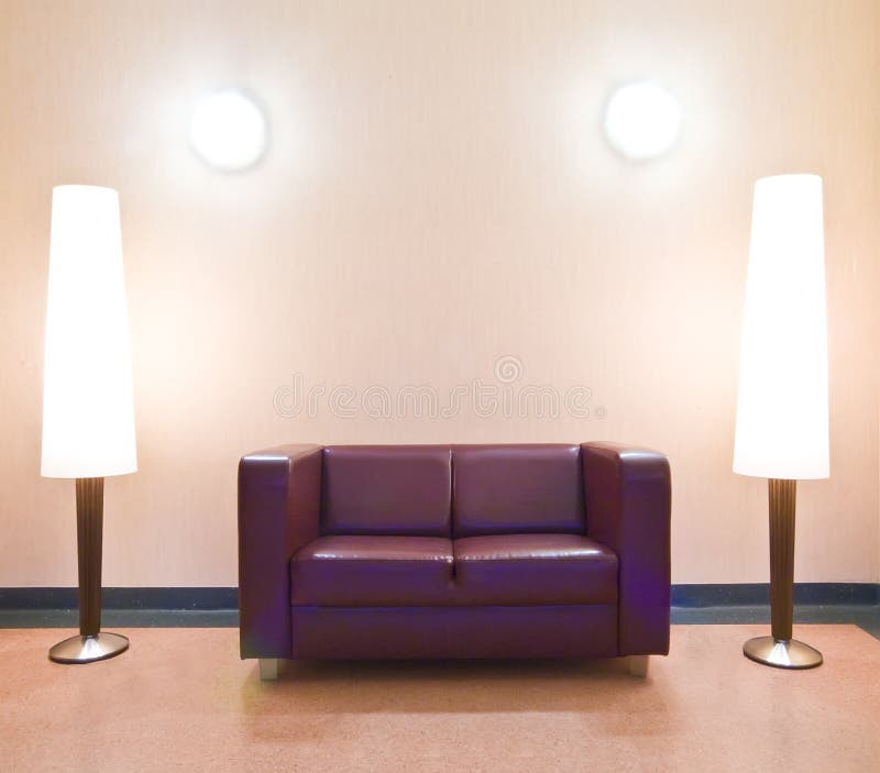 A modern sofa with two floor lamps and two wall lights. A modern sofa with two floor lamps and two wall lights.