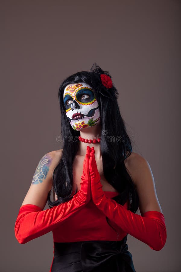 Praying Sugar skull girl in red evening dress and gloves. Praying Sugar skull girl in red evening dress and gloves