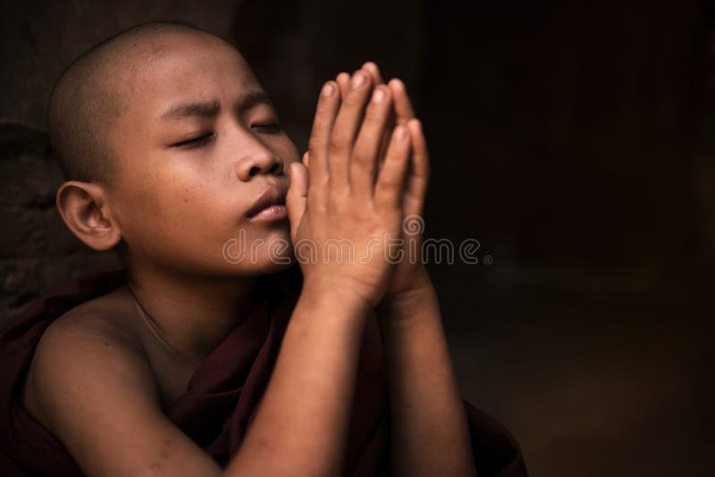 Young little novice monk praying. Young little novice monk praying