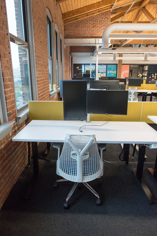 View of trendy modern open concept loft office space with big windows, natural light and a layout to encourage collaboration, creativity and innovation. View of trendy modern open concept loft office space with big windows, natural light and a layout to encourage collaboration, creativity and innovation