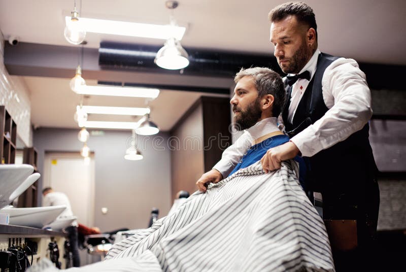 Modnisia mężczyzny klient odwiedza haidresser i hairstylist w fryzjera męskiego sklepie zdjęcia royalty free Modnisia mężczyzny klient odwiedza haidresser i hairstylist w fryzjera męskiego sklepie zdjęcia royalty free