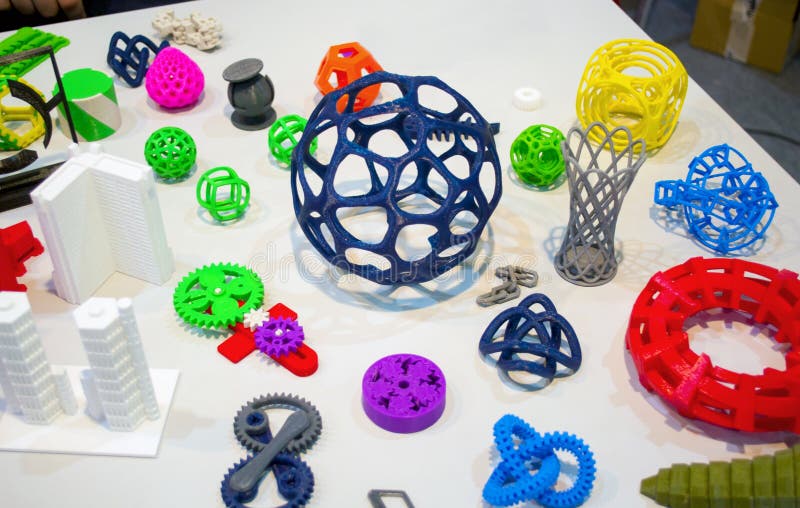 Abstract models printed by 3d printer close-up. Bright colorful objects printed on a 3d printer on a white table. Progressive modern additive technology. Concept of 4.0 industrial revolution. Abstract models printed by 3d printer close-up. Bright colorful objects printed on a 3d printer on a white table. Progressive modern additive technology. Concept of 4.0 industrial revolution