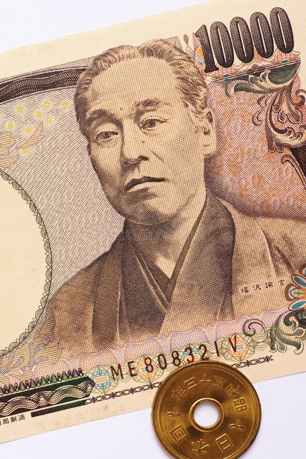 Japanese 10000 yen bill and coin lie on a white paper background. Vertical shot. Japan`s economy, central bank, national currency and savings. Vertical shot. Close-up. Japanese 10000 yen bill and coin lie on a white paper background. Vertical shot. Japan`s economy, central bank, national currency and savings. Vertical shot. Close-up