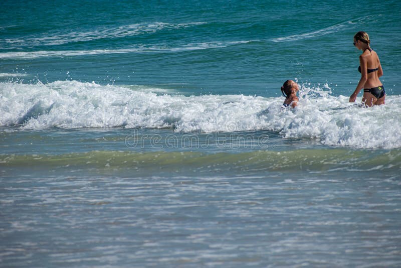 Daytona Beach, Florida. July 06, 2019 Mother and daughter enjoying and playing with waves 3. Daytona Beach, Florida. July 06, 2019 Mother and daughter enjoying and playing with waves 3