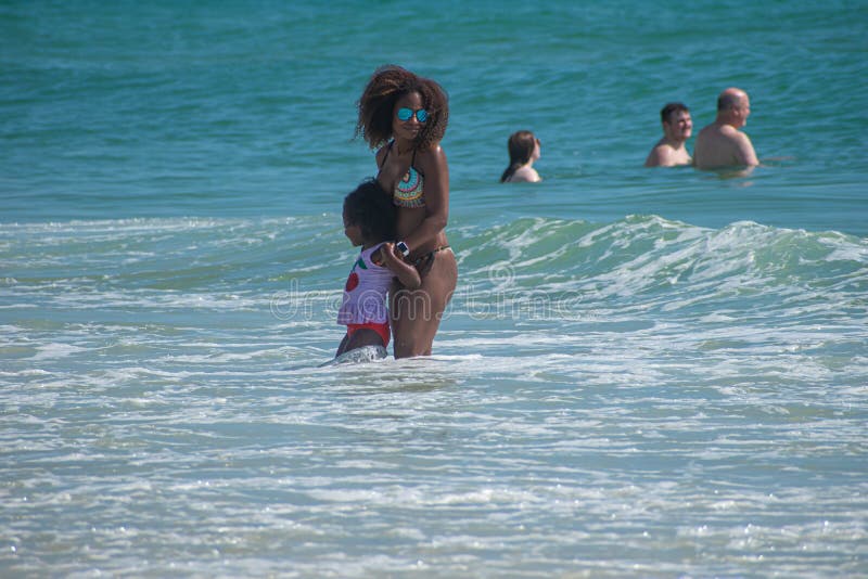 Daytona Beach, Florida. July 06, 2019 Mother and daughter enjoying waves and green sea 3. Daytona Beach, Florida. July 06, 2019 Mother and daughter enjoying waves and green sea 3