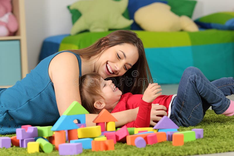 Moeder of kindermeisje het spelen met een kind stock foto Moeder of kindermeisje het spelen met een kind stock foto