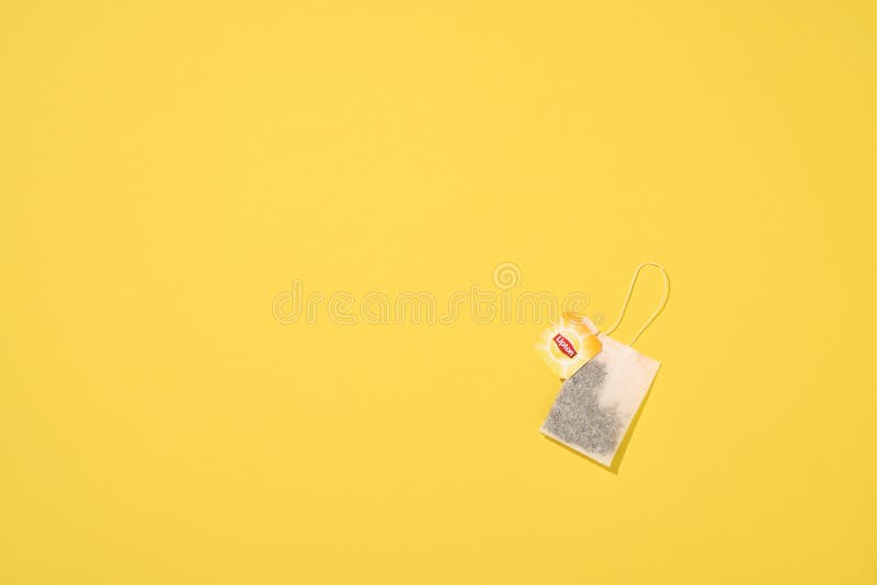 MOGILEV, BELARUS - FEBRUARY 15 2021: Lipton yellow label tea bag on yellow background. Lipton is a British brand of tea owned by