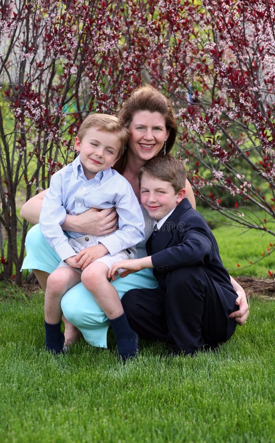 Mother outside with 2 sons all smiling. Mother outside with 2 sons all smiling