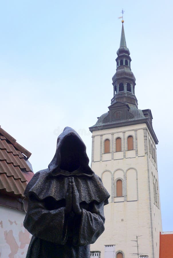 Metal statue of christian monk in Tallin, Estonia. Arms bent with open palms. Metal statue of christian monk in Tallin, Estonia. Arms bent with open palms.