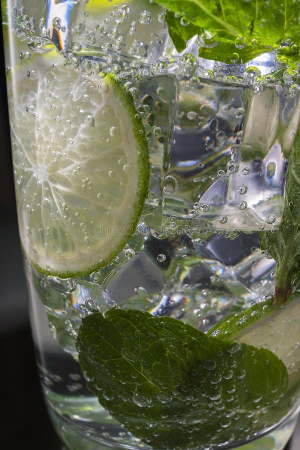 Mojito Alcoholic Cocktail, Rum with Mint Ice, Lime and Tonic, Closeup