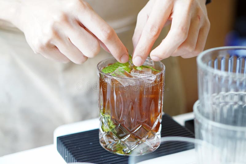 Mojito de café negro picado - Un vaso de café frÃo mezclado con azúcar marrón, frutas tropicales y menta sobre fondo borroso, imágenes de archivo libres de regalías Mojito de café negro picado - Un vaso de café frÃo mezclado con azúcar marrón, frutas tropicales y menta sobre fondo borroso, imágenes de archivo libres de regalías