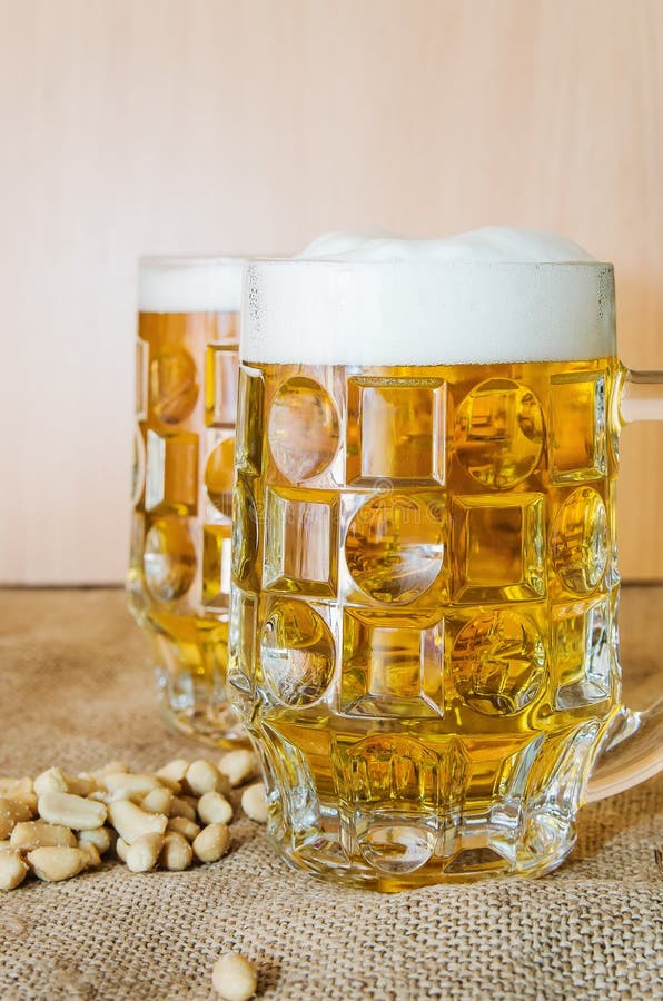 Mok met bier en gezouten pinda's op de lijst royalty-vrije stock fotografie Mok met bier en gezouten pinda's op de lijst royalty-vrije stock fotografie